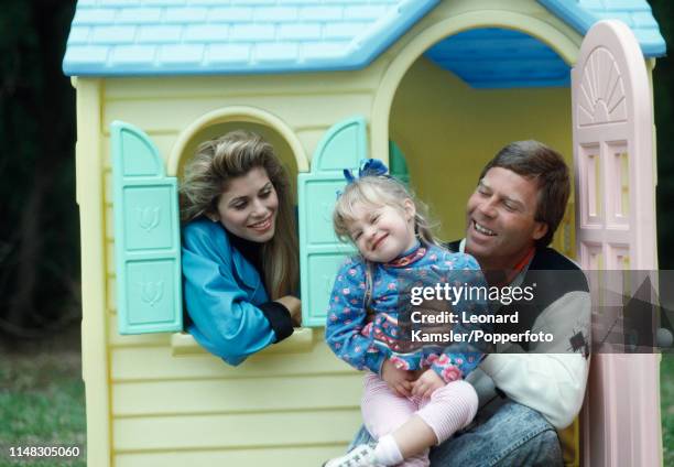 American golfer Ben Crenshaw with his wife Julie and daughter Katherine in Katherine's play house in Austin, Texas, circa 1989.