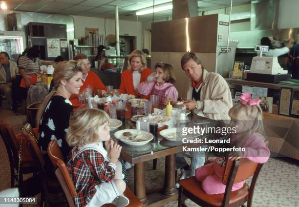 American golfer Ben Crenshaw with his family and friends having breakfast at Cisco's Bakery in Austin, Texas, circa 1989.