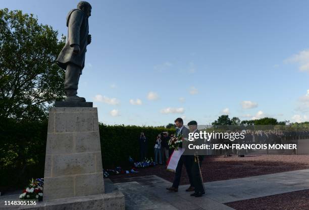 Denmark's army Major General Jens Garly and Denmark's ambassador Michael Starbaek Christensen lay a wreath of flowers during a Danish ceremony on...