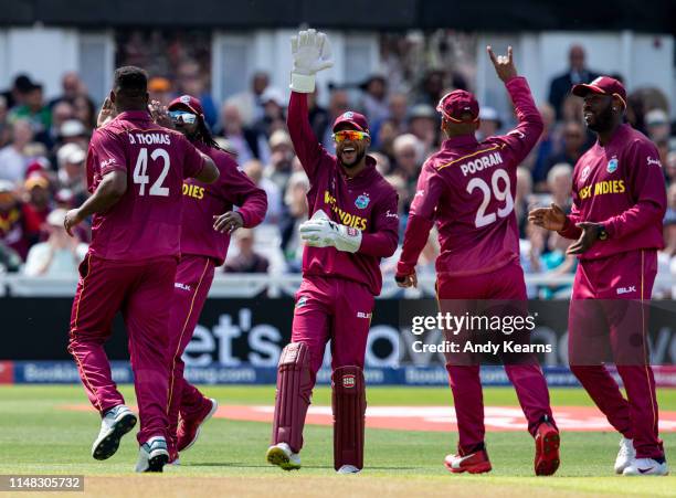 Shai Hope of West Indies leads the celebrations as team mate Oshane Thomas takes the wicket of Aaron Finch of Australia during the Group Stage match...