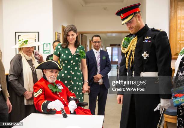 Prince Harry, Duke of Sussex speaks with a group of Chelsea pensioners as he visits the Margaret Thatcher Infirmary whilst attending Founder's Day at...