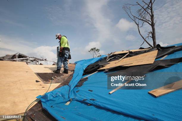 Contractor repairs the roof of a home damaged by Hurricane Michael on May 10, 2019 in Panama City, Florida. Seven months after the category five...