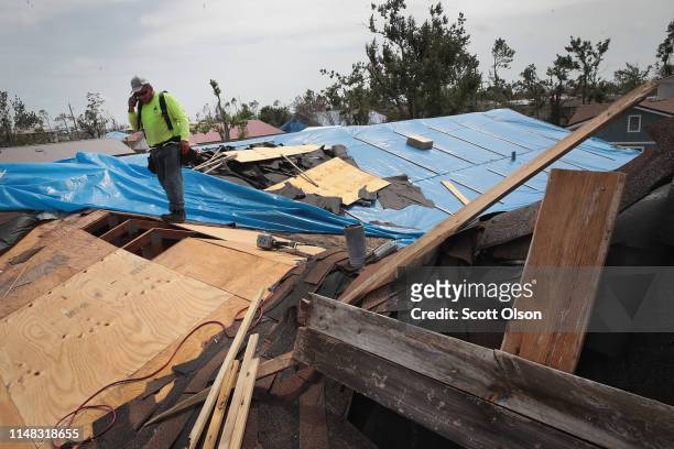 Contractor repairs the roof of a home damaged by Hurricane Michael on May 10, 2019 in Panama City, Florida. Seven months after the category five...