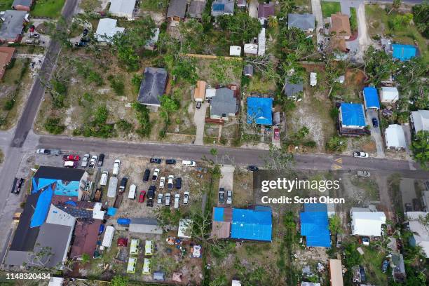 Blue tarps covering roofs damaged by Hurricane Michael dot the landscape on May 10, 2019 in Panama City, Florida. Seven months after the category...