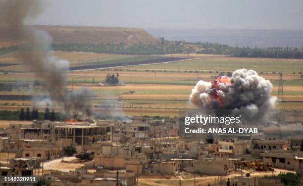 Smoke and fire rise following reported Syrian government forces' bombardment on the town of Khan Sheikhun in the southern countryside of the...