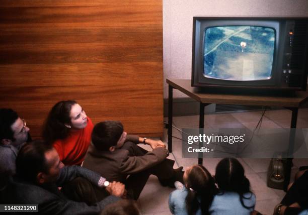 People watch the first color television program, diffused on the second channel, in Paris, 01 October 1967. Diffused thanks to SECAM system, the...
