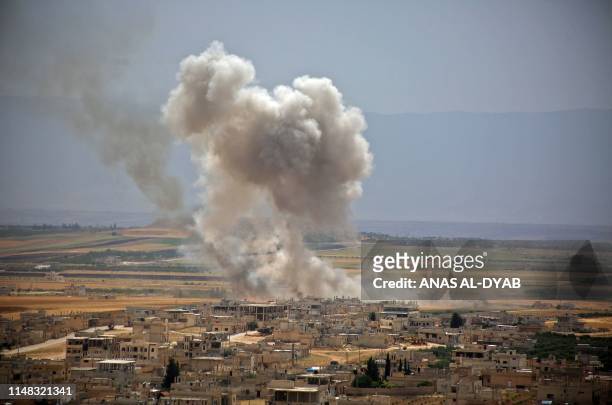 Plumes of smoke rise following reported Syrian government forces' bombardment on the town of Khan Sheikhun in the southern countryside of the...