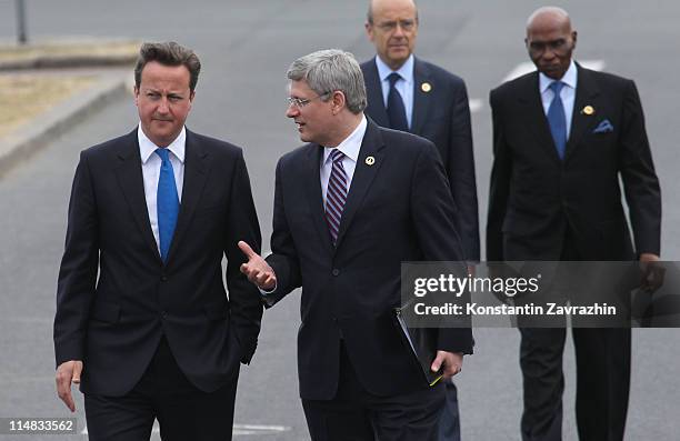 British Prime Minister David Cameron and Canadian Prime Minister Stephen Harper arrive to the lunch at the G8 Summit on May 27, 2011 in Deauville,...