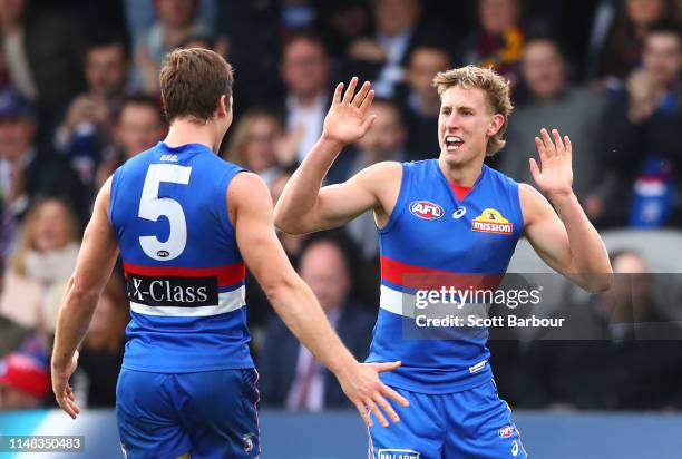 Aaron Naughton of the Bulldogs celebrates after kicking a goal with Josh Dunkley of the Bulldogs during the round eight AFL match between the Western...