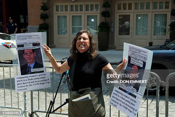 Suzannah Troy shouts in protest in front of the townhouse in the Tribeca area of Manhattan where former IMF head Dominique Strauss-Kahn is being held...
