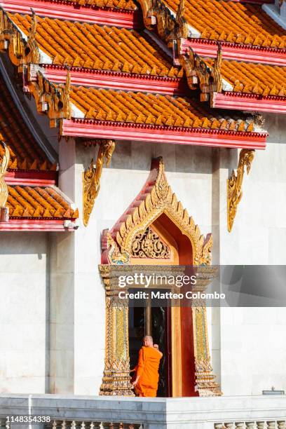 buddhist monk entering in the temple, bangkok, thailand - wat benchamabophit stock pictures, royalty-free photos & images