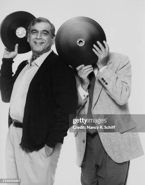 Film producer Ismail Merchant and director James Ivory, holding reels of film, 1990. They are partners in the Merchant-Ivory production company.