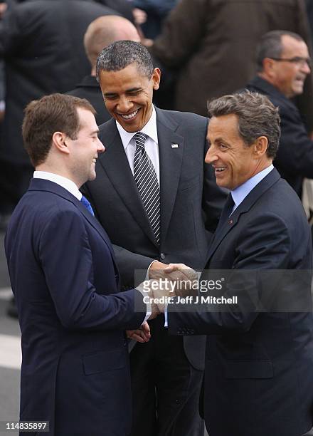 President Barack Obama , French President Nicolas Sarkozy and Russian President Dmitry Medvedev join hands as they arrive at the G8 summit on May 26,...