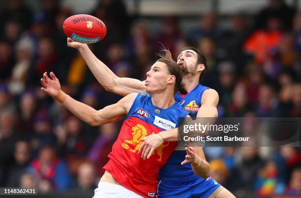 Eric Hipwood of the Lions and Easton Wood of the Bulldogs compete for the ball during the round eight AFL match between the Western Bulldogs and the...