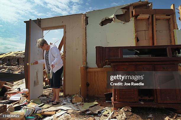 Sharon Tucker looks for items to salvage from what used to be her living room in the home she lived in for four years before it was destroyed by a...