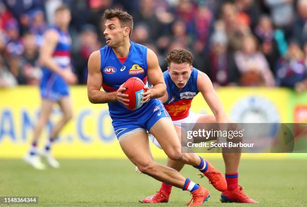 Sam Lloyd of the Bulldogs runs with the ball during the round eight AFL match between the Western Bulldogs and the Brisbane Lions at MARS Stadium on...