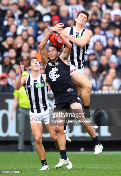 Brody Mihocek of the Magpies marks over Dale Thomas of the Blues during the round eight AFL match between the Carlton Blues and the Collingwood...