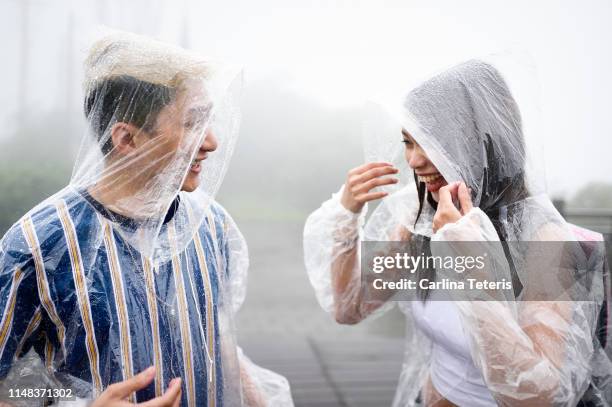 young couple in th rain - philippines friends stock pictures, royalty-free photos & images