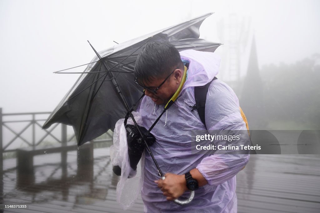 Man with a broken umbrella in a storm