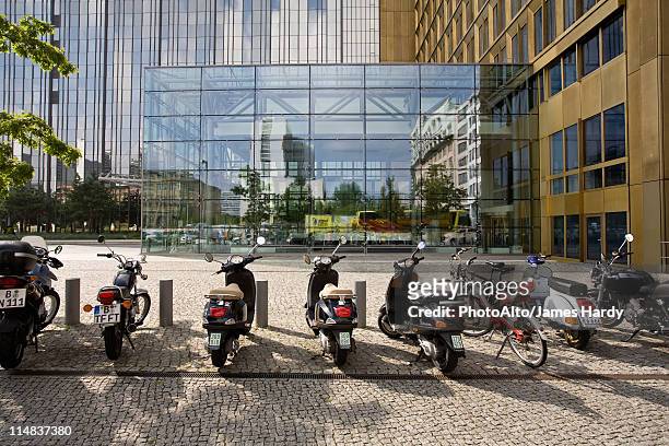 germany, berlin, mopeds parked in front of axel springer publishing house - moped stock-fotos und bilder