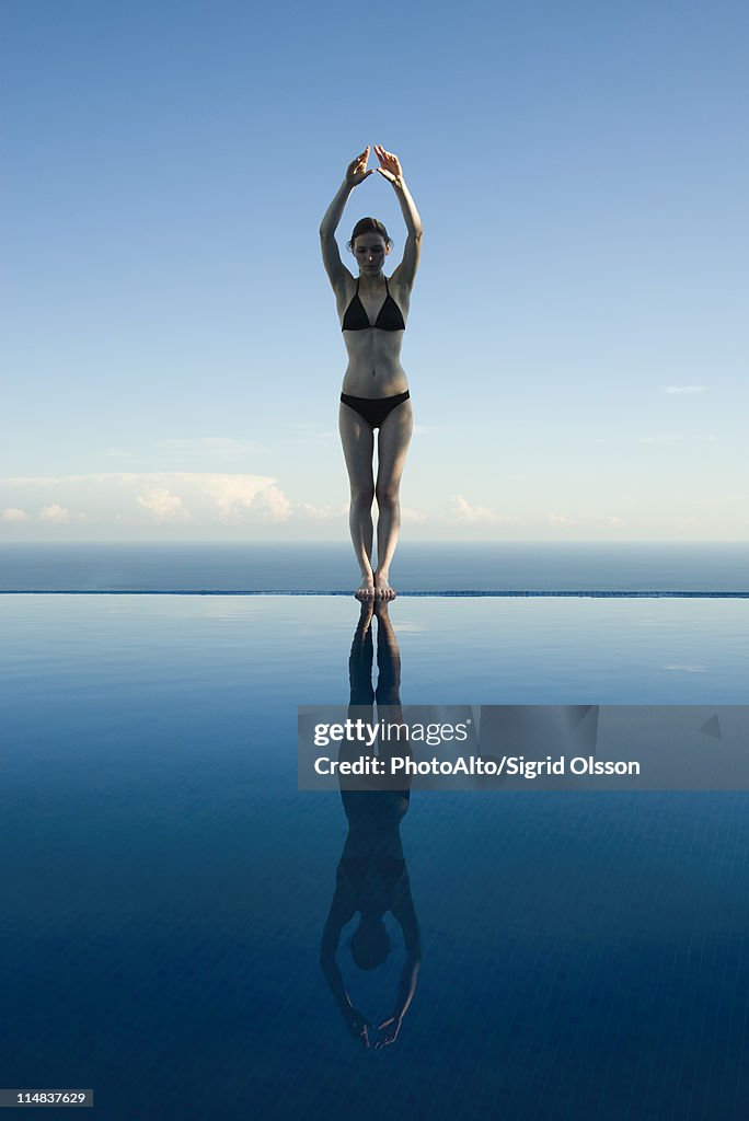 Woman preparing to dive into pool