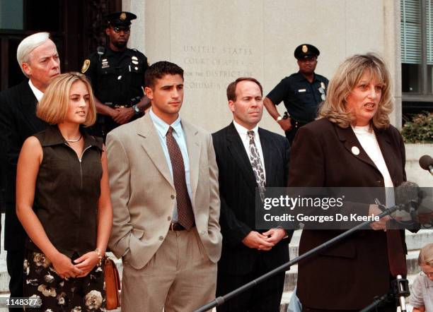 Linda Tripp along with her children and attorney talks to the press outside the Federal Courthouse July 29, 1998 in Washington, DC. After finishing...