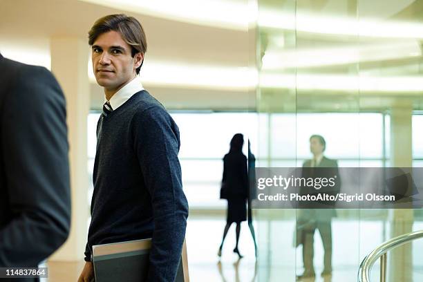 businessman in lobby, portrait - yuppie stock-fotos und bilder