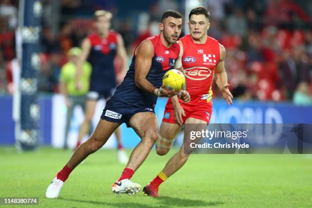 Christian Salem of the Demons kicks during the round eight AFL match between the Gold Coast Suns and the Melbourne Demons at Metricon Stadium on May...