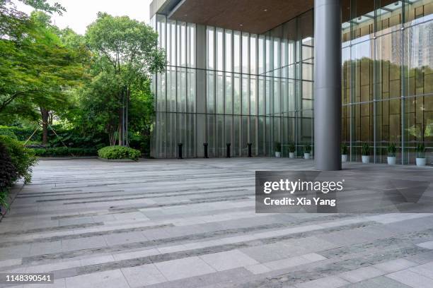 empty parking lot in front of a modern building - glass entrance stock pictures, royalty-free photos & images