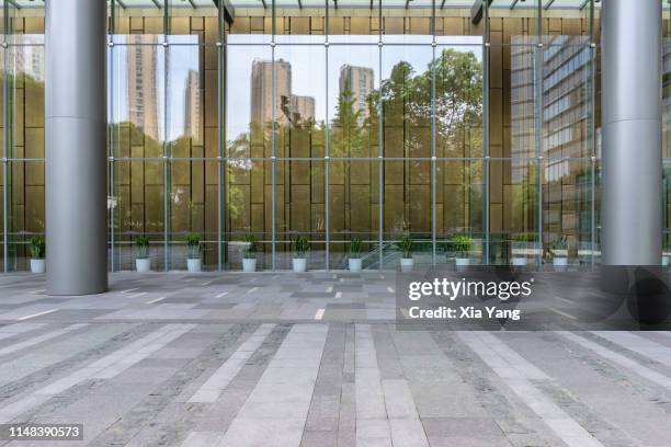 empty parking lot in front of a modern building - glass entrance stock pictures, royalty-free photos & images