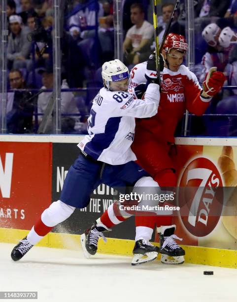 Oliver Lauridsen of Denmark challenges Charles Bertrand of France during the 2019 IIHF Ice Hockey World Championship Slovakia group A game between...