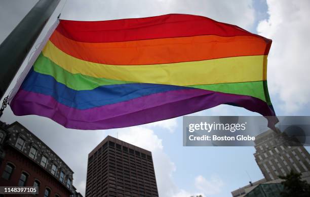 The rainbow flag flies over Boston during the Pride Week Flag Raising Ceremony at City Hall in Boston on May 31, 2019. The event officially...