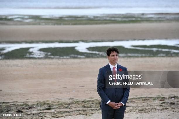 Canadian Prime Minister Justin Trudeau stands after laying a wreath during an international ceremony on Juno Beach in Courseulles-sur-Mer, Normandy,...