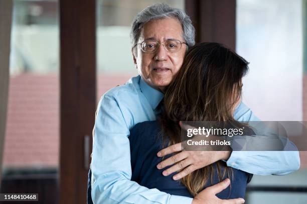 woman sharing a moment with senior father - father in law stock pictures, royalty-free photos & images