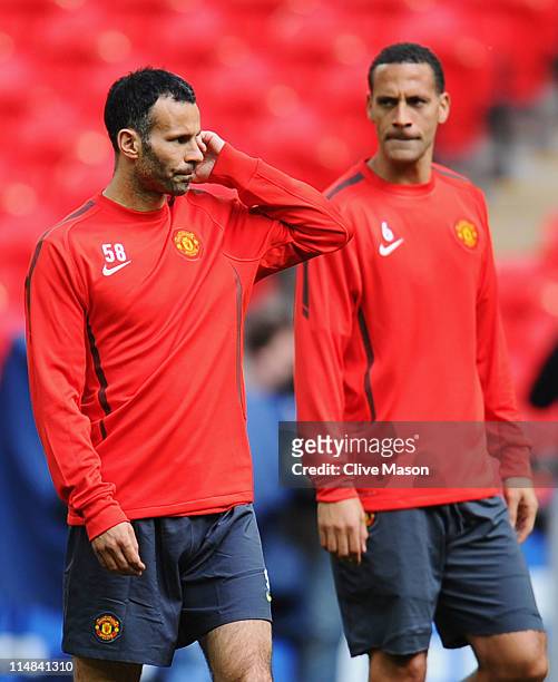 Ryan Giggs and Rio Ferdinand of Manchester United look on during a Manchester United training session prior to the UEFA Champions League final versus...