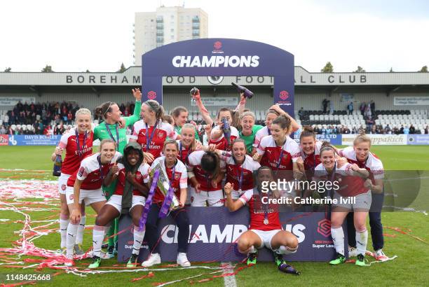 Arsenal celebrate with the trophy after winning the Women's Super League after the WSL match between Arsenal Women and Manchester City at Meadow Park...