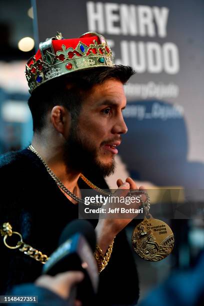 Flyweight champion Henry Cejudo interacts with the media during the UFC 238 Ultimate Media Day at the United Center on June 6, 2019 in Chicago,...