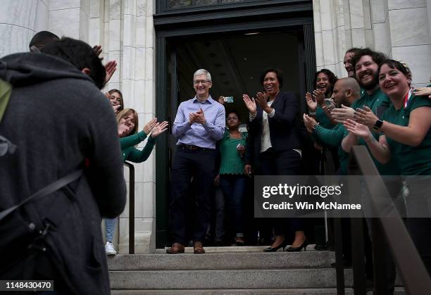 Apple CEO Tim Cook and Washington DC Mayor Muriel Bowser welcome customers to the opening of a new Apple Store at the historic Carnegie Library...