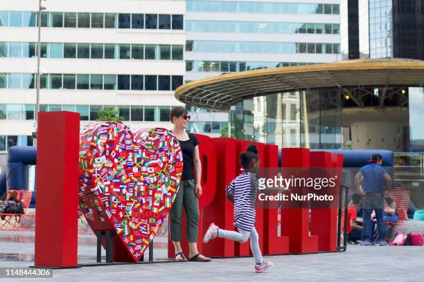 Tourists and locals take pictures at a life-size I Love Philly sign at LOVE park in Center City Philadelphia, PA on June 6, 2019.