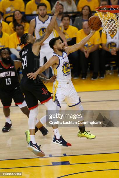 Stephen Curry of the Golden State Warriors drives to the basket against Gerald Green of the Houston Rockets during Game Five of the Western...