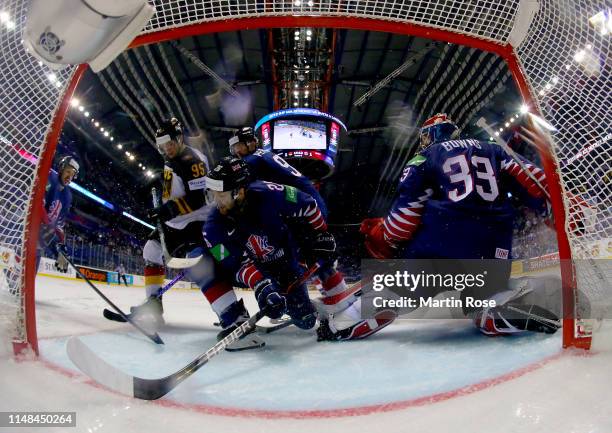 Frederik Tiffels of Germany challenges Evan Mosey of Great Britain during the 2019 IIHF Ice Hockey World Championship Slovakia group A game between...