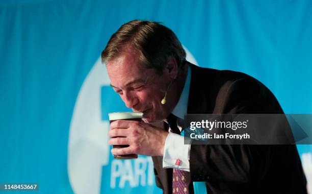 Brexit Party leader Nigel Farage is handed a drink after his speech during a Brexit Party campaign at Rainton Meadows Arena in Houghton Le Spring on...