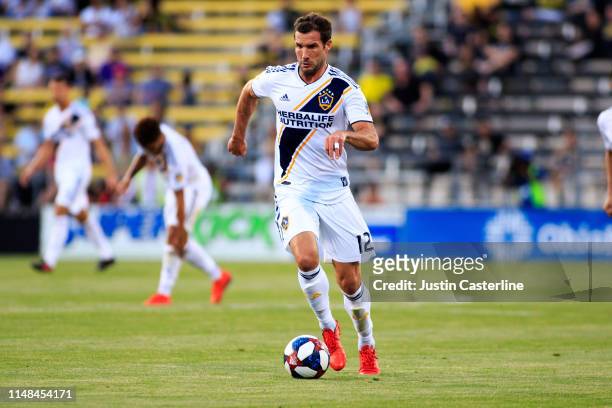 Chris Pontius of the LA Galaxy brings the ball up the field against the Columbus Crew SC during the second half at MAPFRE Stadium on May 08, 2019 in...