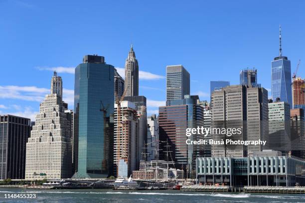 view of lower manhattan's east river waterfront, with the freedom tower,  120 wall street, and other modern highrise office buildings facing fdr drive along the eastern edge of lower manhattan, new york city - wall street lower manhattan stock pictures, royalty-free photos & images