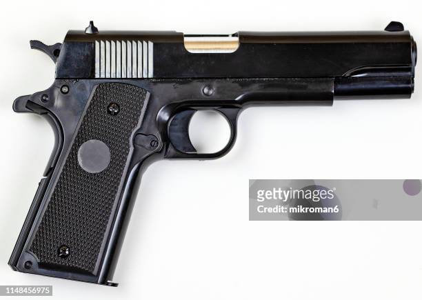 low angle view of gun over white background - pistol fotografías e imágenes de stock