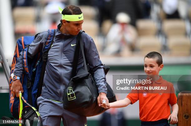 Spain's Rafael Nadal arrives on the tennis court prior to his men's singles semi-final match against Switzerland's Roger Federer on day 13 of The...