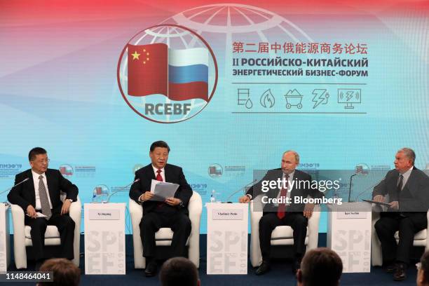 Vladimir Putin, Russias president, center right, Xi Jinping, Chinas president, center left, and Igor Sechin, chief executive officer of Rosneft Oil...