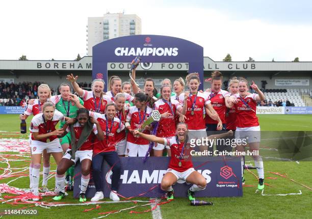 Arsenal celebrate with the trophy after the WSL match between Arsenal Women and Manchester City at Meadow Park on May 11, 2019 in Borehamwood,...