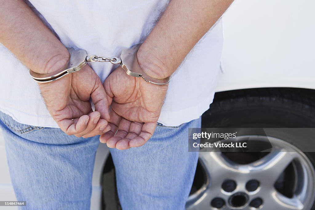 USA, Illinois, Metamora, midsection of man with handcuffs on hands