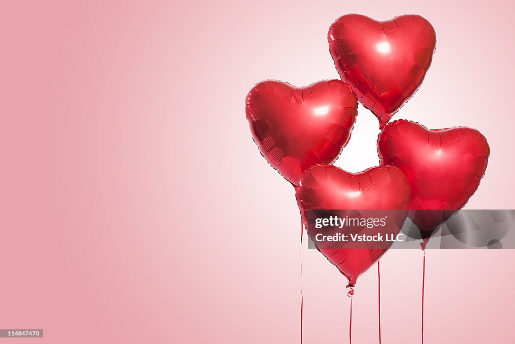 Studio shot of red heart shaped balloons